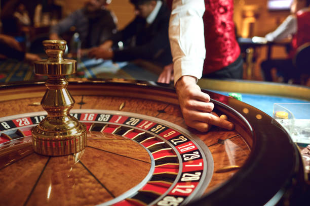 Hand of a croupier on a roulette whell in a casino. Roulette betting poker. Gambling in a casino.